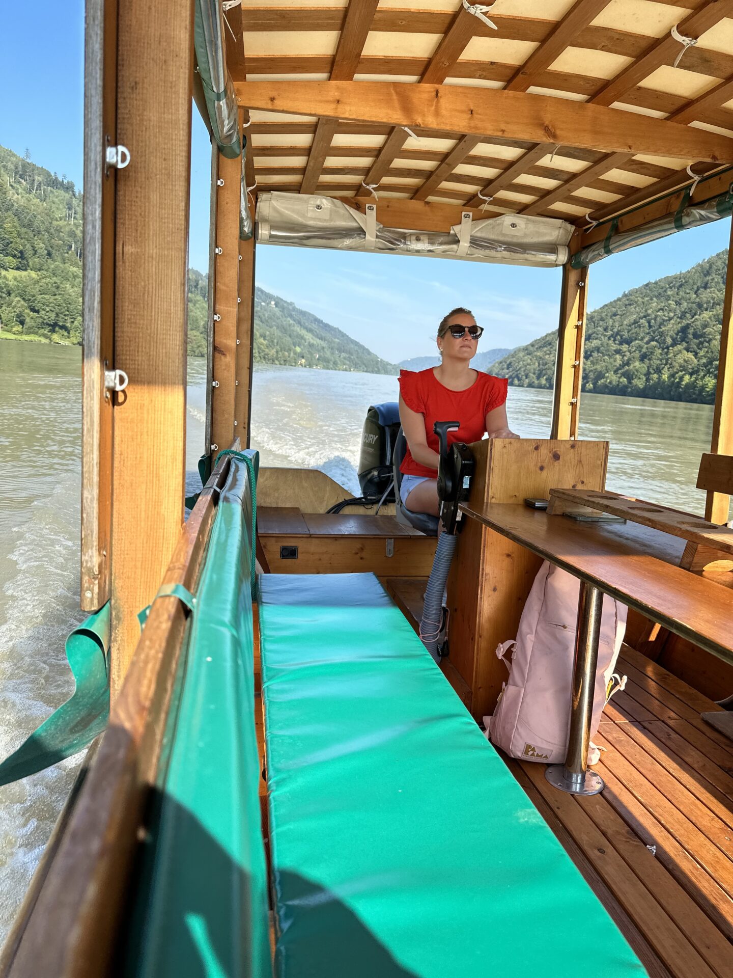 Nicole, a boat captain with Flossmeister Regensburg, at the helm of the barge on the Danube